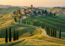Iconic Tuscan landscape with rolling green hills, cypress-lined roads, and a medieval hilltop village